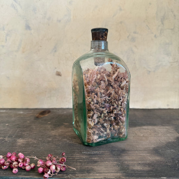 Antique Glass Bottle Filled with Flowers